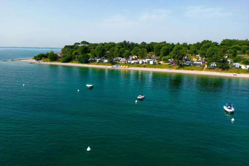 una vista aerea di un grande bacino idrico con imbarcazioni di Sivinos Camping Boutique a Manerba del Garda