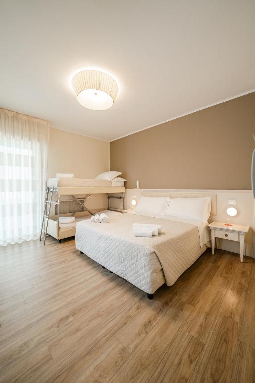 Postel nebo postele na pokoji v ubytování Hotel Orchidea