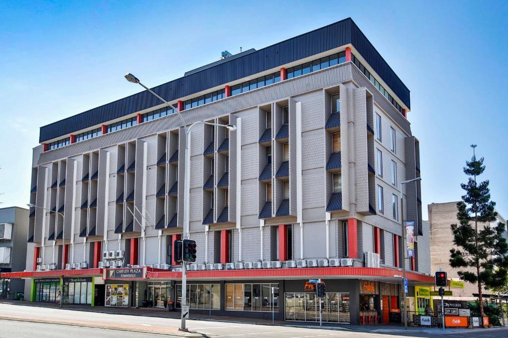 a large building on the corner of a street at Madison Plaza Townsville in Townsville