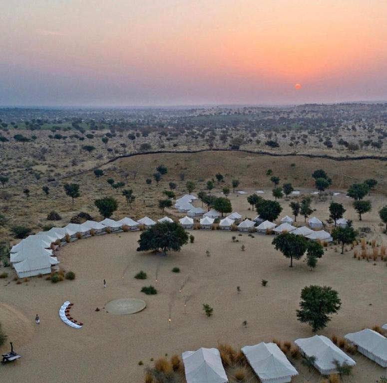 an aerial view of a desert with tents and trees at Journey Desert Camp Jaisalmer in Jaisalmer
