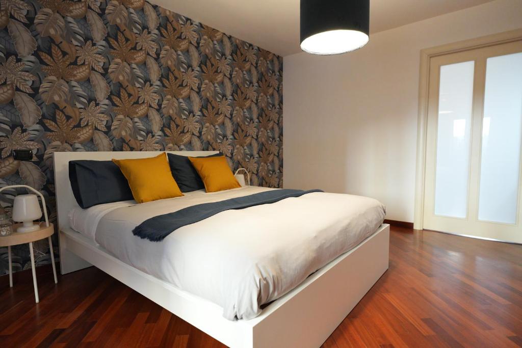 a bedroom with a bed with yellow and blue pillows at Due Passi Dal Borgo Antico in Bari