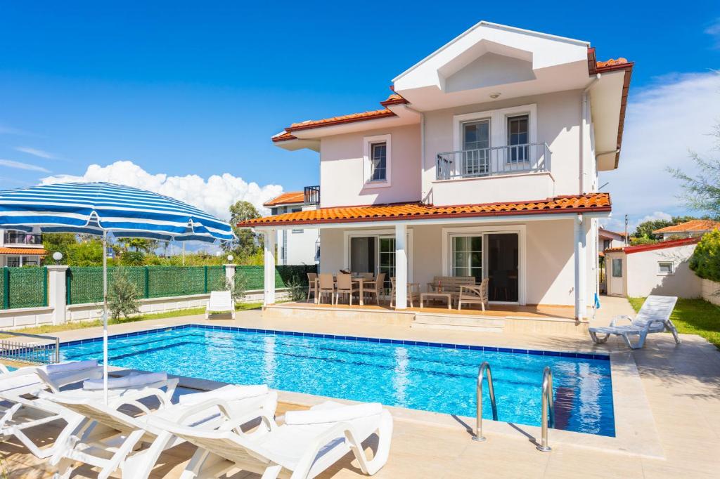 a villa with a swimming pool and a house at Villa Vista in Dalyan