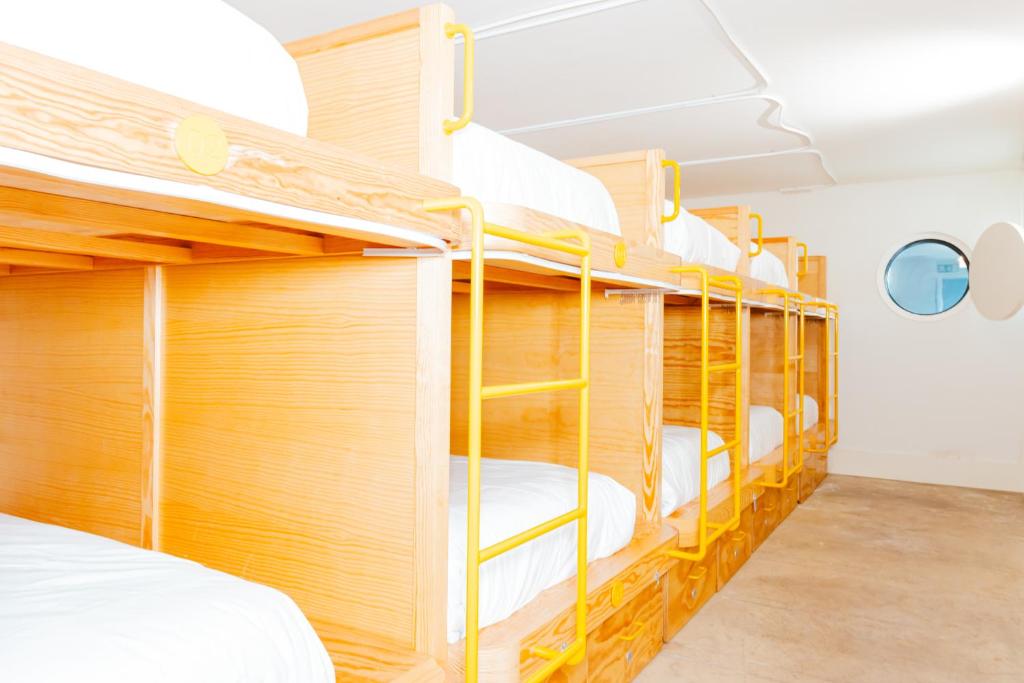 a group of bunk beds in a dorm room at Surf & Sea Suites in Parede