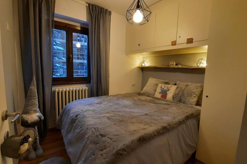 a bedroom with a bed and a window at Ski House Marmotta in Borgata Sestriere