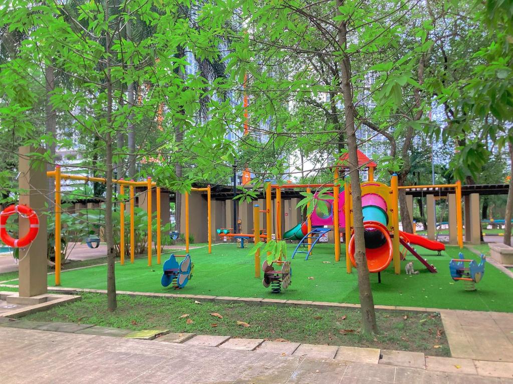 a playground with colorful playground equipment in a park at NR CYBER ROOMSTAY 2-Shared Apartment in Cyberjaya