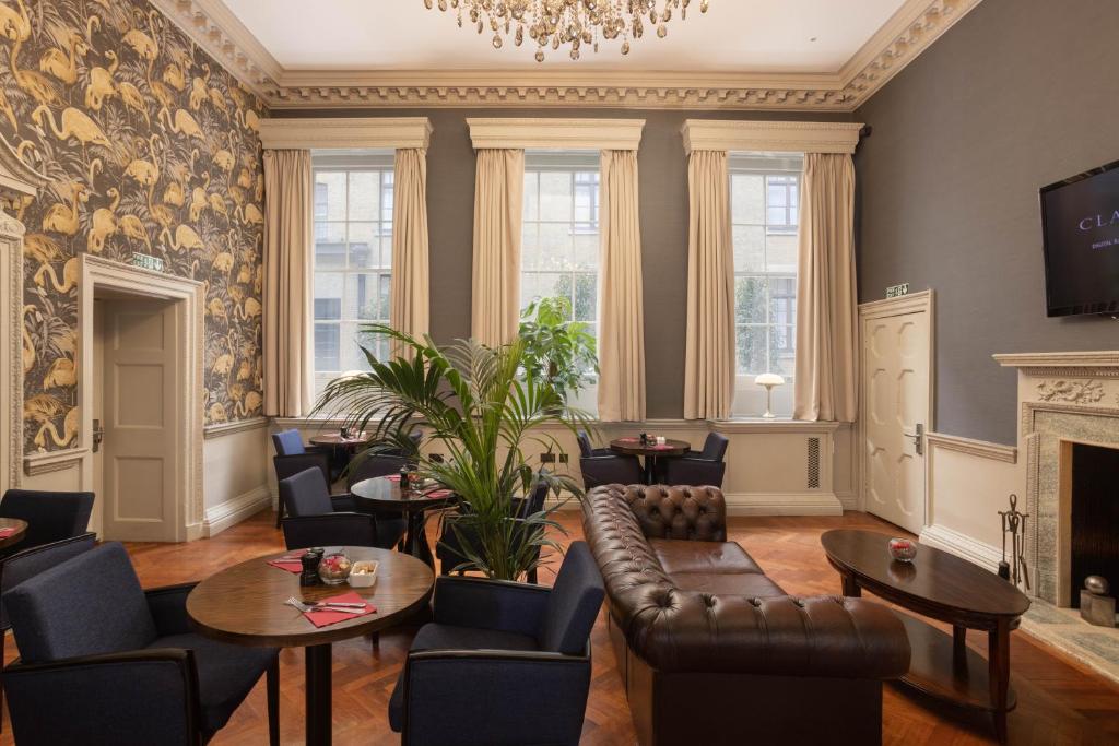 a living room with chairs and tables and a fireplace at Montcalm Brewery, London City in London