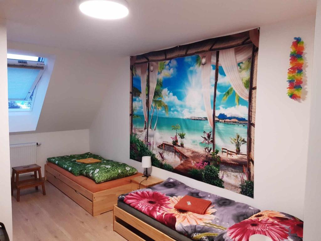 a room with two beds and a painting on the wall at Odal Hawaii sro ubytování vzdělávání in Pěnčín