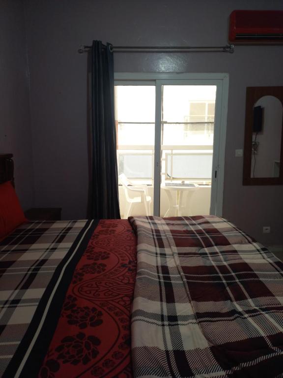 a bedroom with a bed and a window with a balcony at Peace N Quiet aux Almadies in Dakar
