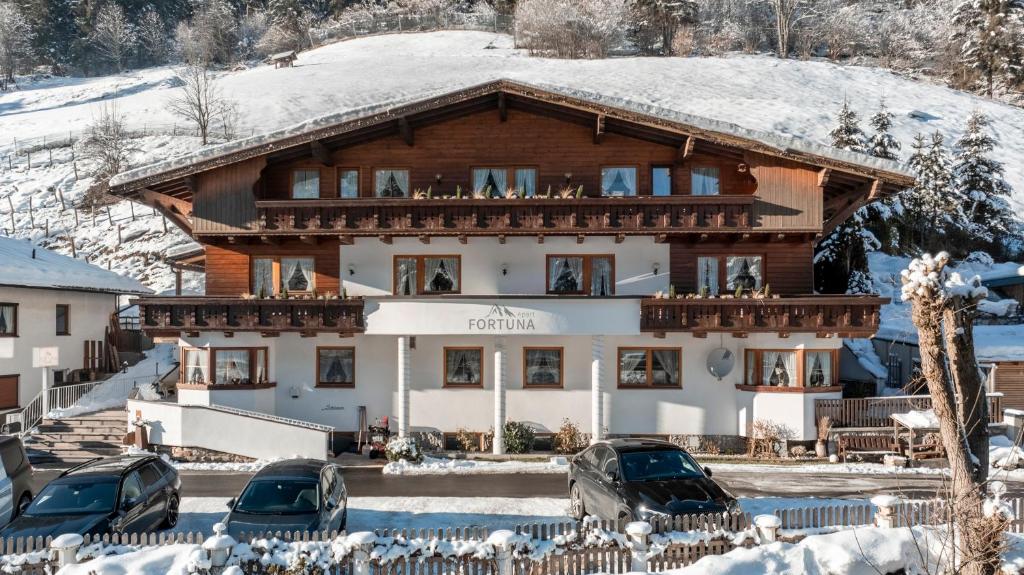 a large building with cars parked in front of it at Apart Fortuna in See