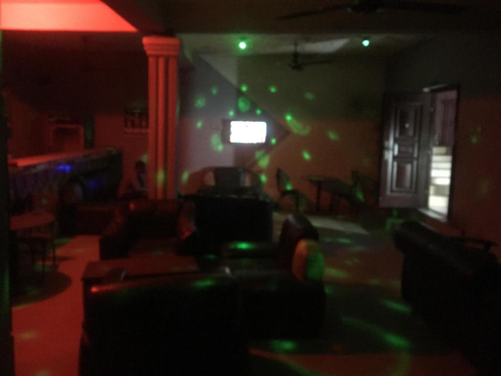 a living room with green lights on the wall at Hy Angels Hotel in Port Harcourt