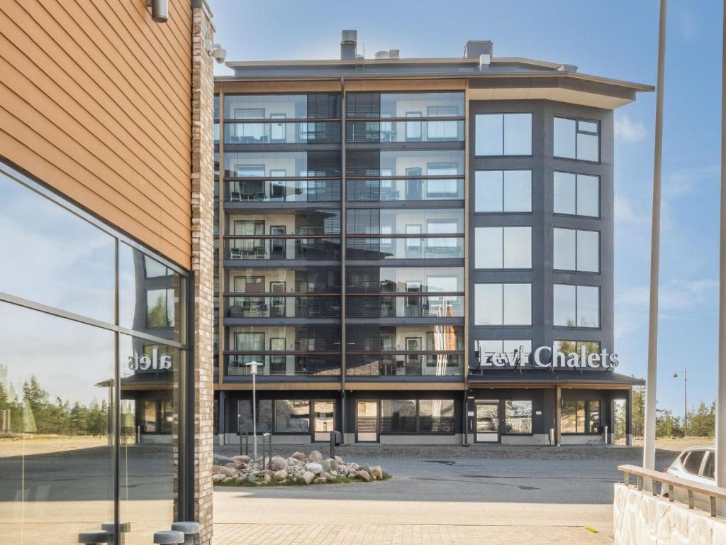 an apartment building with a large glass facade at Holiday Home Levi chalet 1602 by Interhome in Sirkka
