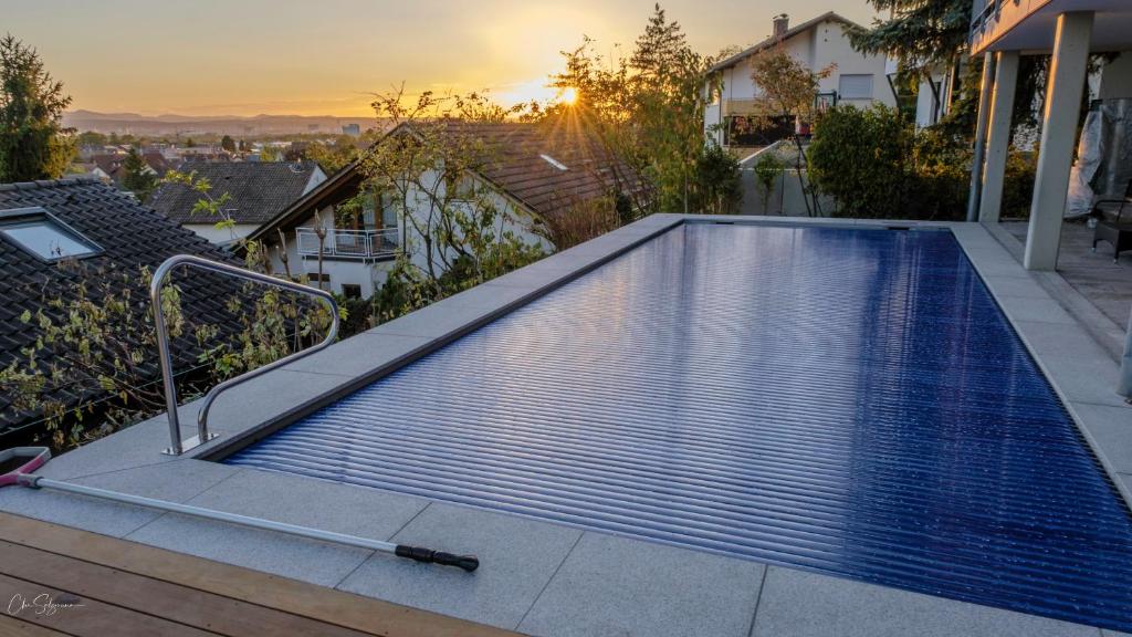 a swimming pool on top of a house at Panoramahaus am Schlipfweg in Weil am Rhein