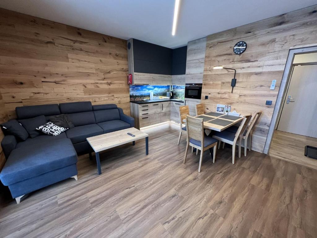 a living room with a couch and a table at Apartment Říčky v Orlických horách C21 by Interhome in Říčky