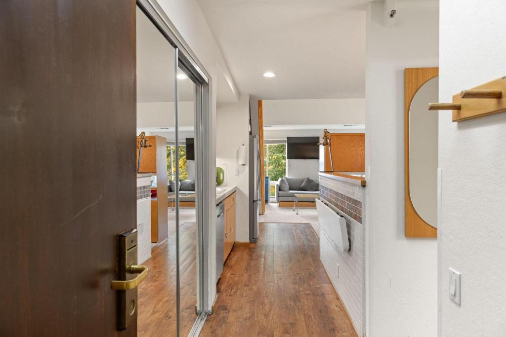 a kitchen with a hallway leading to a living room at Studio Loft #308 in Olympic Valley