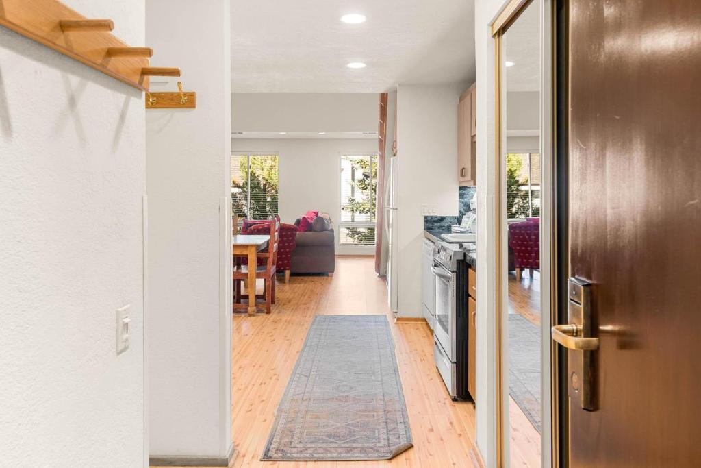 a hallway leading to a kitchen and a dining room at Palisades Tahoe Lodge Rentals Studio Loft #315 in Olympic Valley