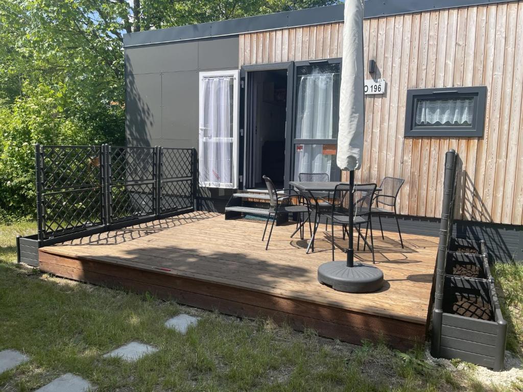 a wooden deck with a table and chairs on it at Holiday Home Renate by Interhome in Wemding