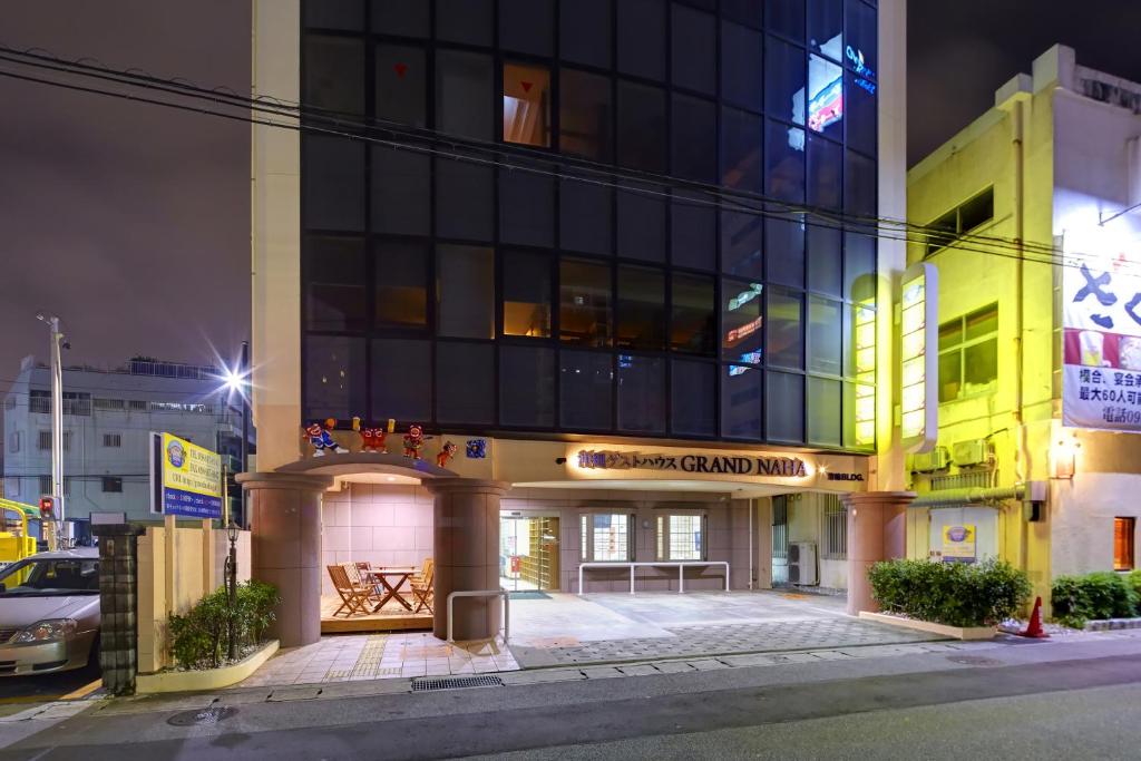 a building on a city street at night at Guest House Grand Naha in Naha