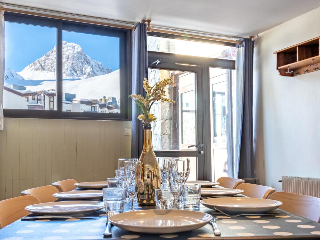 a table with glasses and a vase on top of it at Apartment Les Hauts du Val Claret - Val Claret-24 by Interhome in Tignes