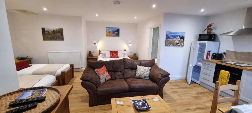 a living room with a couch and a bed at Wastwater Cottage for Scafell and Wasdale in Seascale