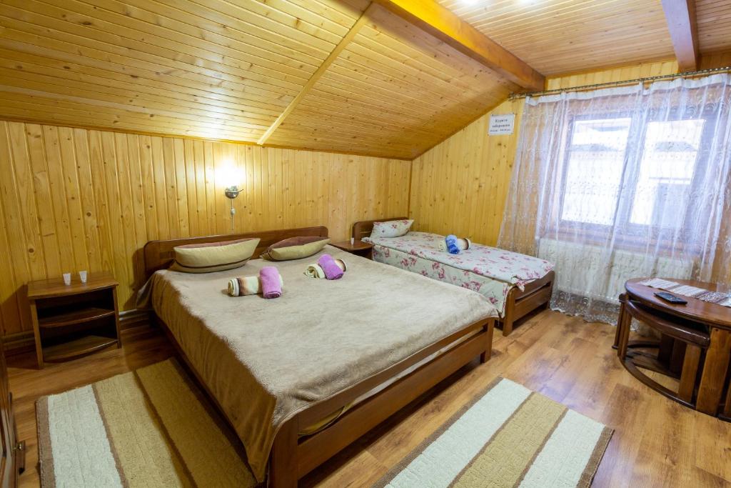 Postel nebo postele na pokoji v ubytování Садиба У Василини та Романа