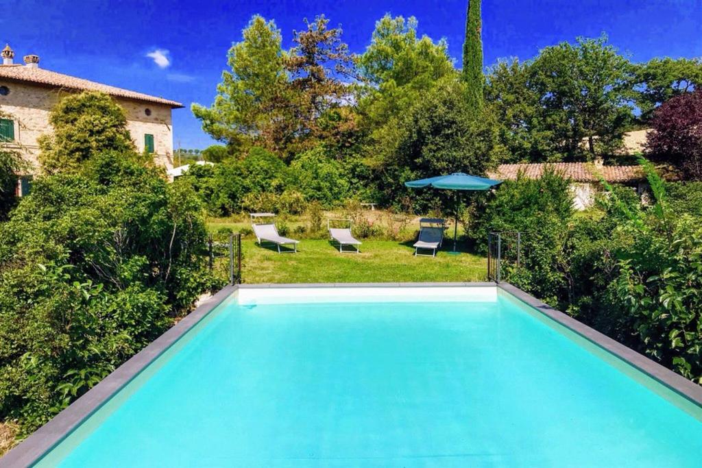 a swimming pool in the yard of a house at Adam House - Exc Pool in Marzolini