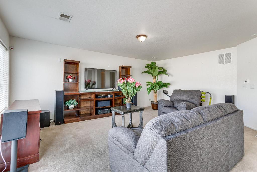 a living room with two couches and a tv at Spacious Home with Patio Near Denver Airport in Aurora
