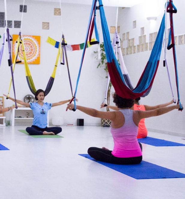 two women in a yoga class with suspended ropes at Hotel Nautico in Santa Cruz de Tenerife
