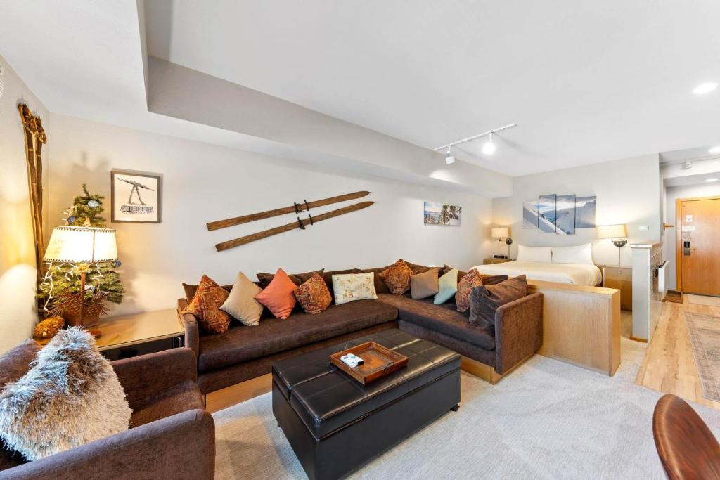 a living room with a couch and a bed at Palisades Tahoe Lodge Rentals Studio #207 in Olympic Valley