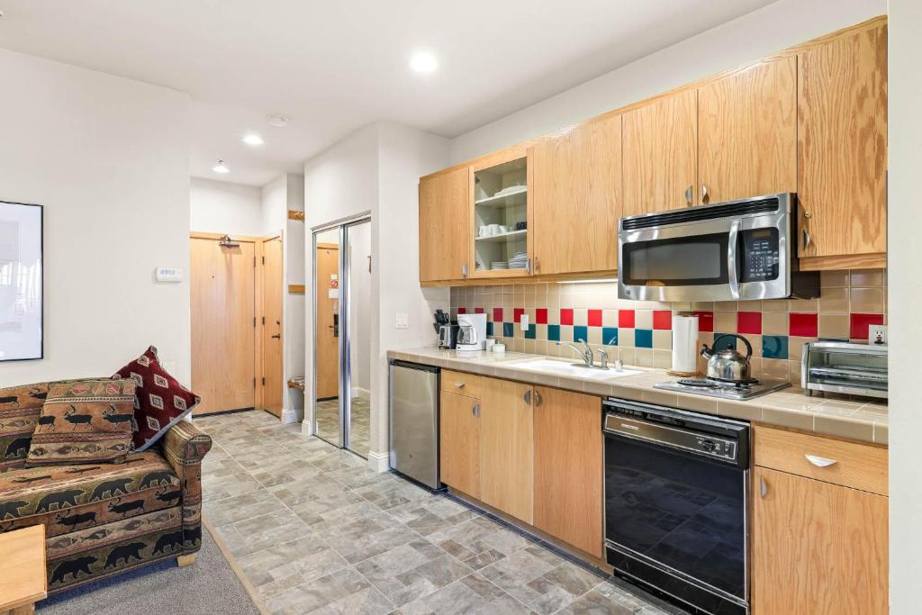 a kitchen with wooden cabinets and a microwave at Studio #154 in Olympic Valley