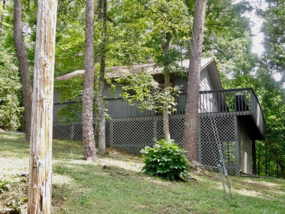 a house with a balcony in the woods at Robin's Roost in Sevierville