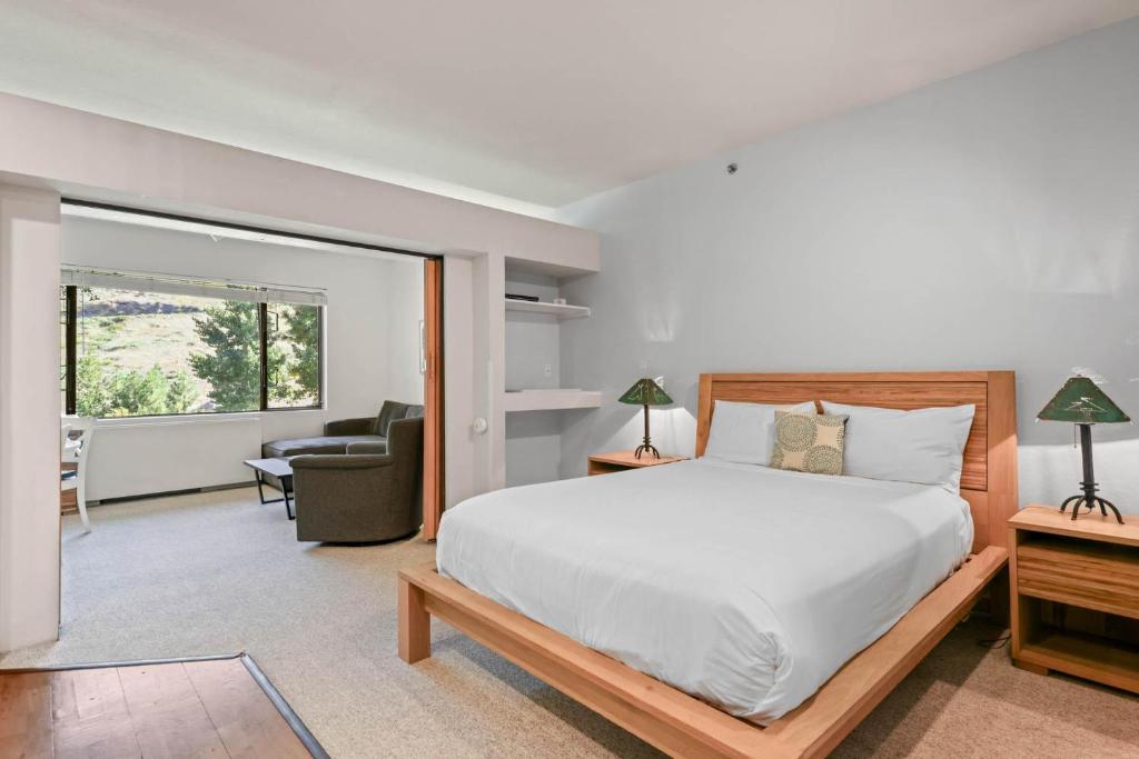 a bedroom with a bed and a living room at Studio #247 in Olympic Valley