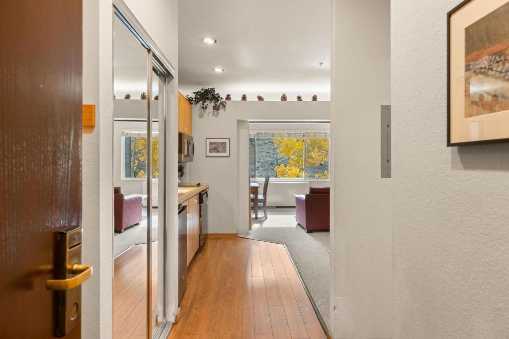 a hallway with a kitchen and a dining room at Palisades Tahoe Lodge Rentals Studio #253 in Olympic Valley