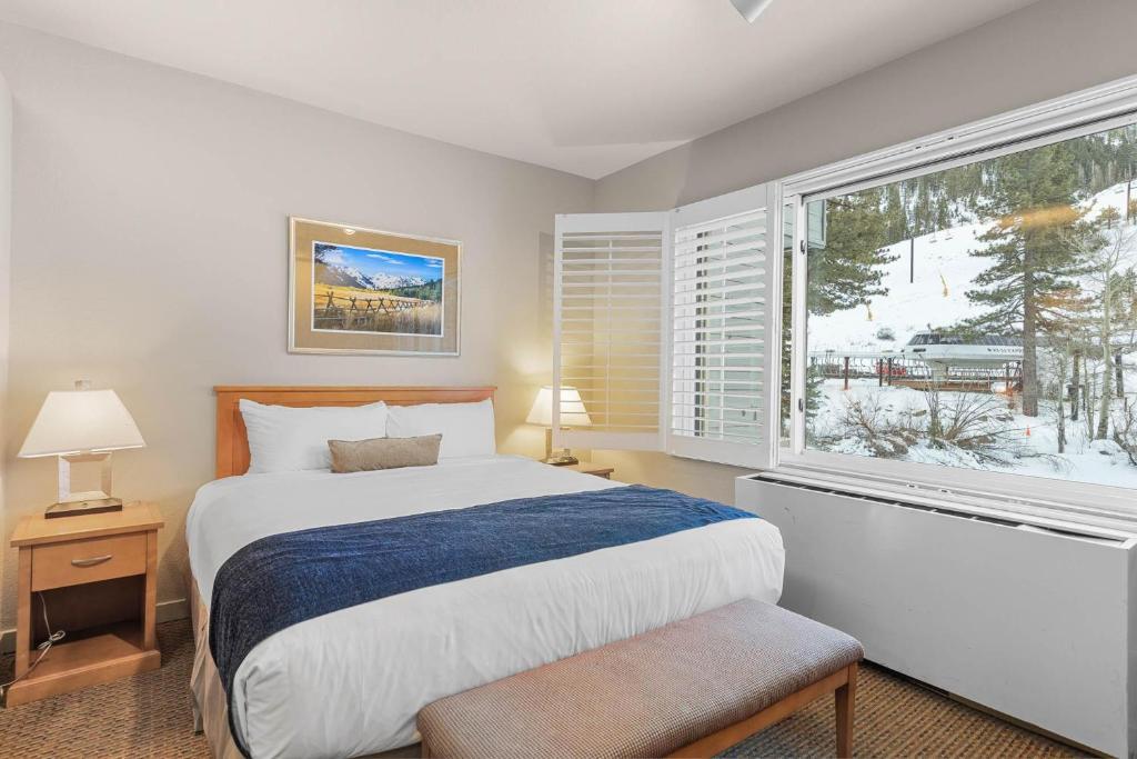 a bedroom with a bed and a large window at Studio #255 in Olympic Valley