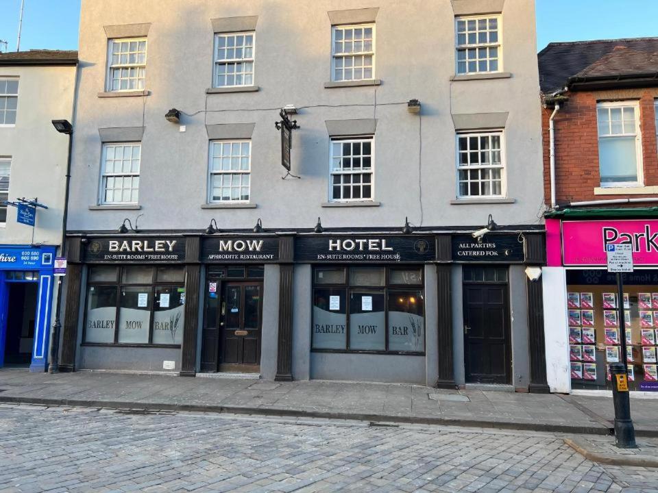 a row of shops on a street in front of a building at Barley Mow Hotel in Pontefract