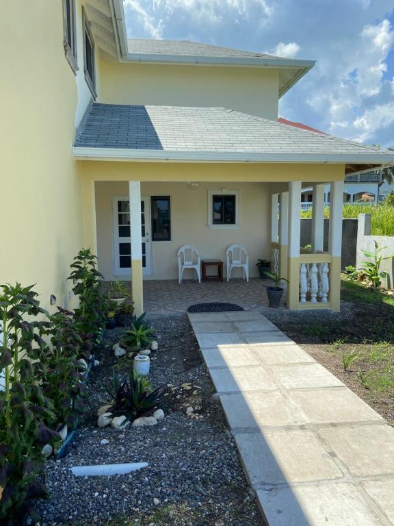 a house with a pathway leading to the front yard at 1 Bed Cottage in Gated Community in Banks