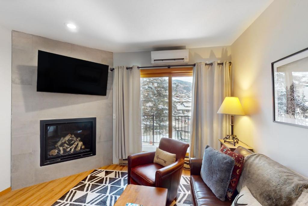 a living room with a couch and a fireplace at Snow Flower 101 in Steamboat Springs