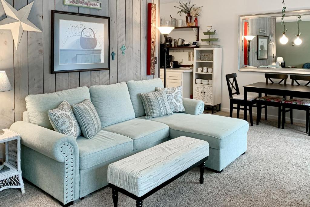 a living room with a blue couch and a table at The Mountain Sanctuary in Campton