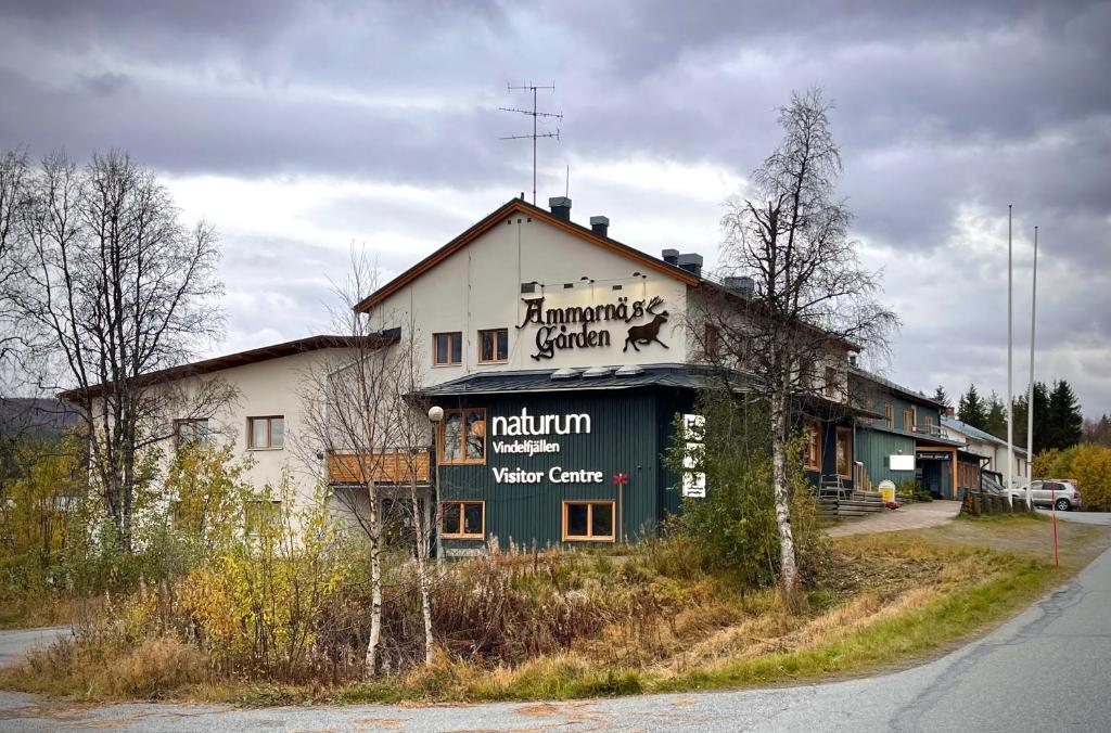 a building with a sign on the side of it at Vandrarhemsboende på Ammarnäsgården in Ammarnäs