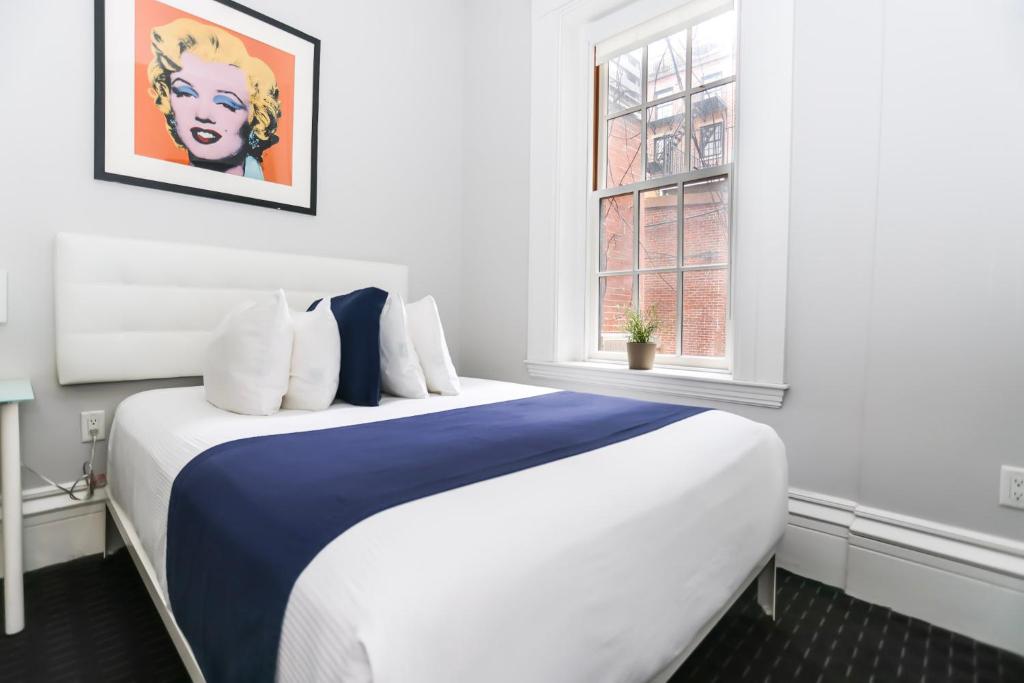 a large bed in a room with a window at Charming & Stylish Studio on Beacon Hill #2 in Boston