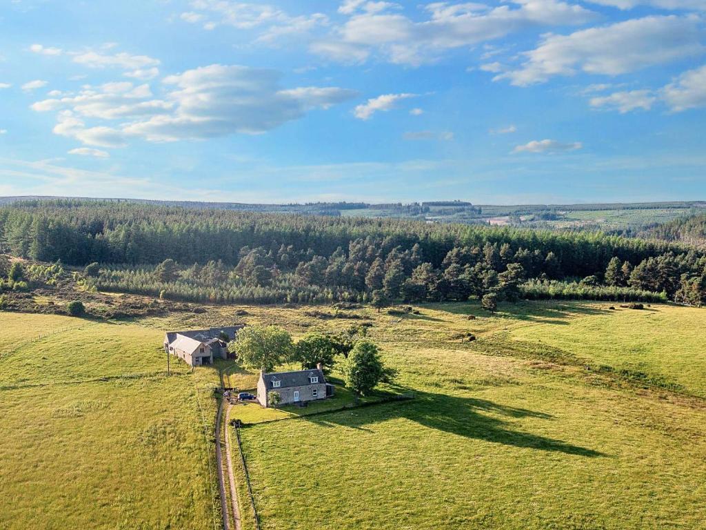 an aerial view of a house in a green field at 3 bed in Carron CA227 in Carron