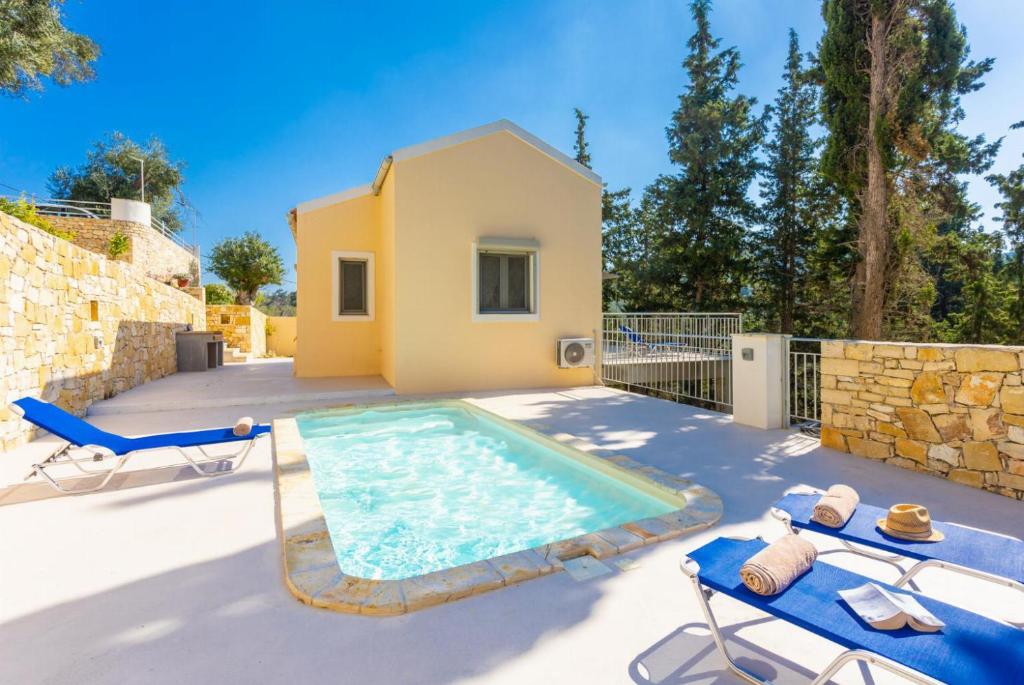 a villa with a swimming pool and a house at Villa Alexandros in Gaios