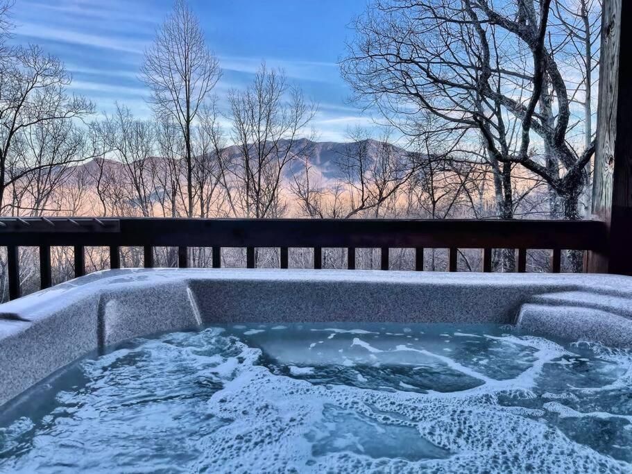 a jacuzzi tub with a view of the mountains at Mountain Escape Chalet-Paradise! in Gatlinburg