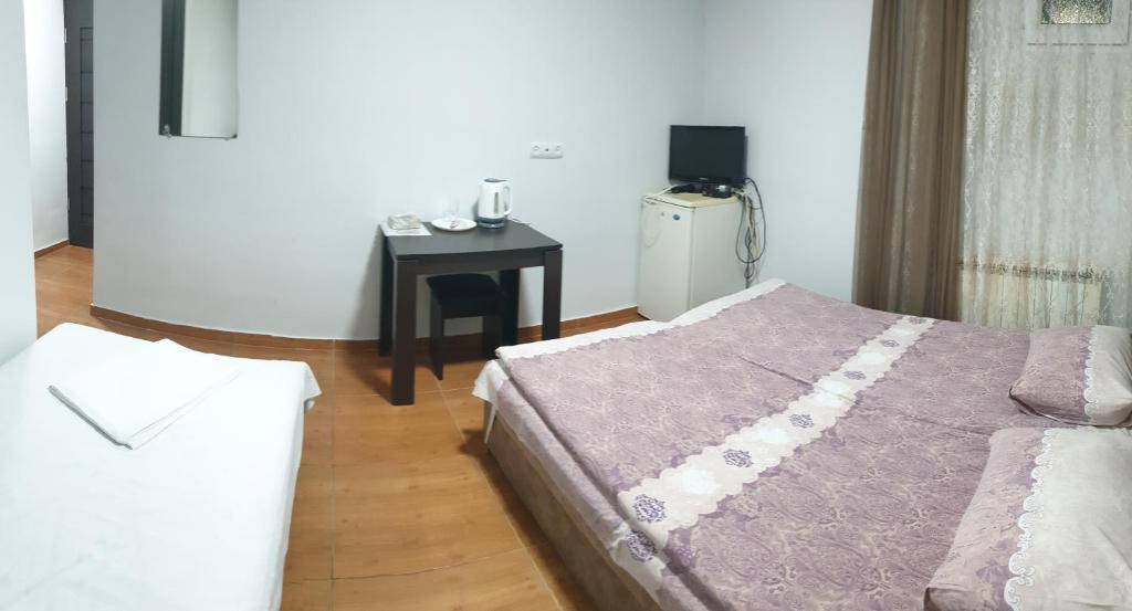 Postel nebo postele na pokoji v ubytování Hotel Amigo