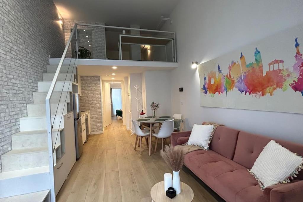 uma sala de estar com um sofá e uma escada em Hola Pamplona! em Pamplona