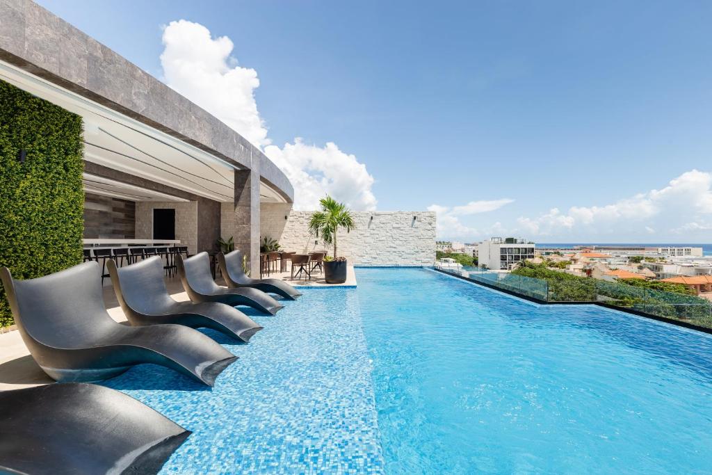 a swimming pool on the roof of a building at A Perfect Place in Playa del Carmen