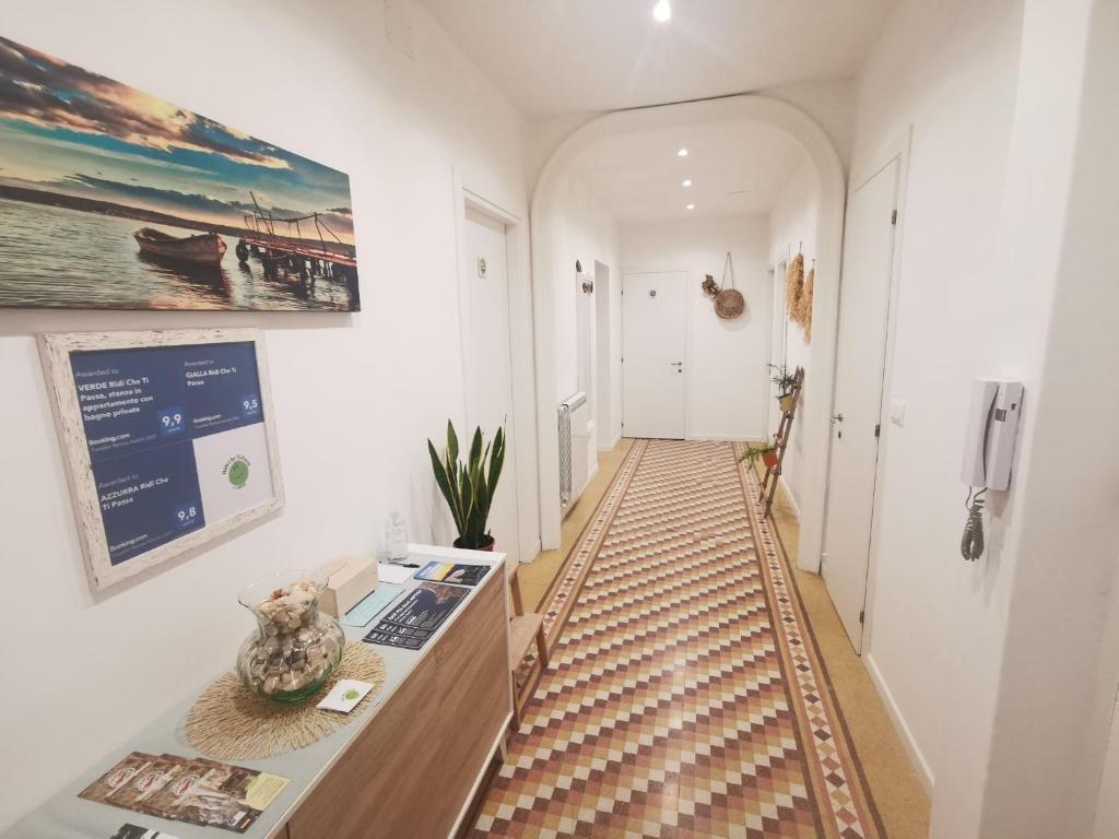 a hallway with a table with a vase on it at VERDE Ridi Che Ti Passa in Alassio