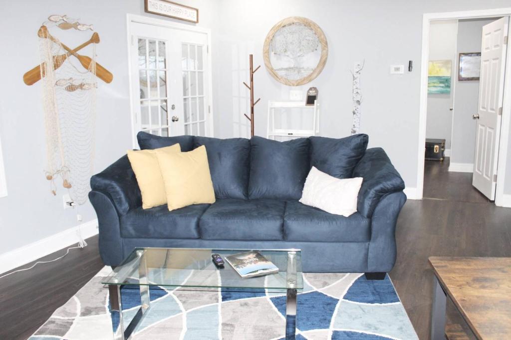 a blue couch in a living room with a glass table at Great Outdoors in Lagrange in LaGrange