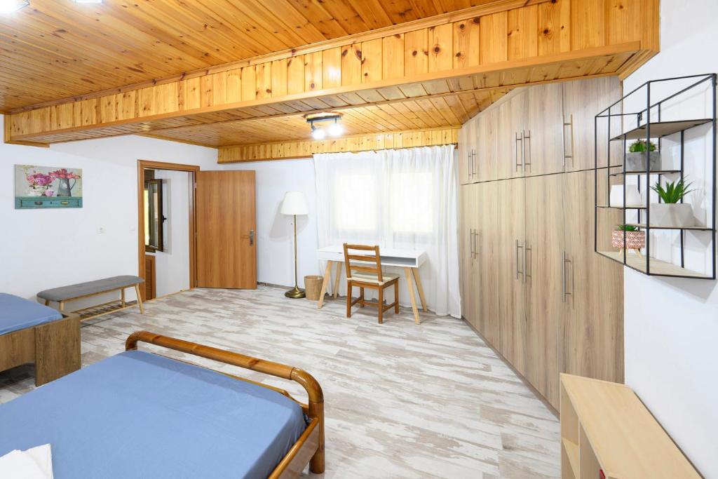a room with a bed and a dining room at Small Villa Gerani in Agios Vlasios