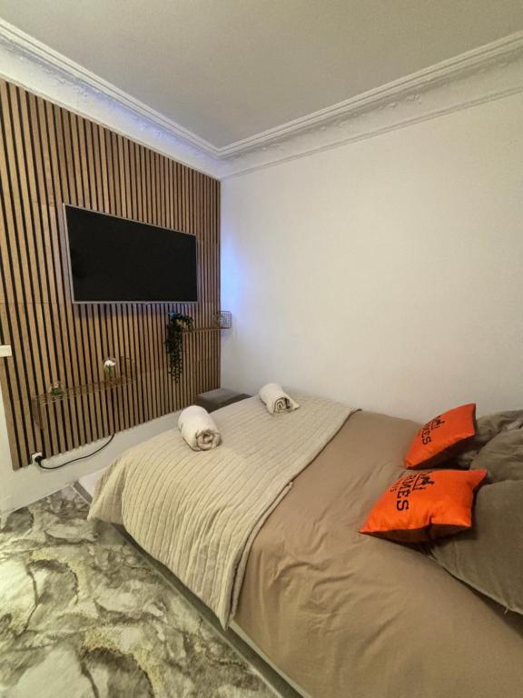 a bedroom with a bed with two dogs on it at Appartement à côté Tour Eiffel in Paris