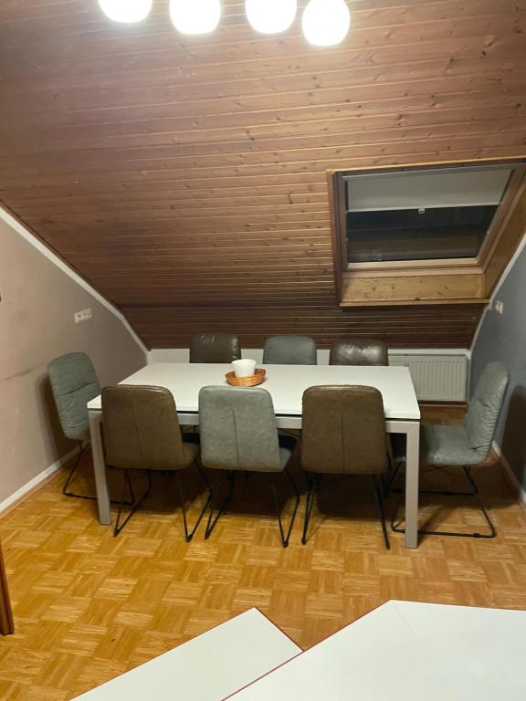 ein Esszimmer mit einem weißen Tisch und Stühlen in der Unterkunft Monteur Zimmer bis 16 Personen Preis verhandelbar in Linsengericht